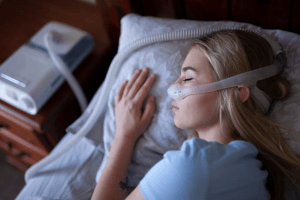 Image of a Woman Sleeping in a CPAP machine